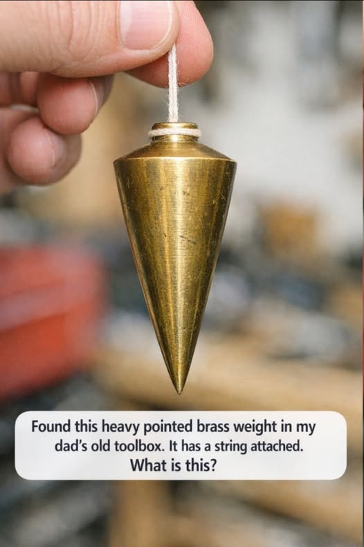 Found this heavy pointed brass weight in my dad’s old toolbox. It has a string attached. What is this?